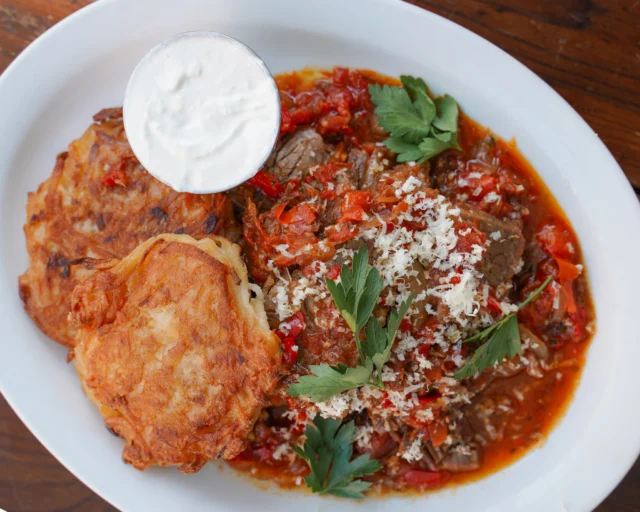 Brisket braised overnight in a sweet and sour tomato sauce, crisp latkes, horseradish cream.
Feels like a hug from Bubbie.