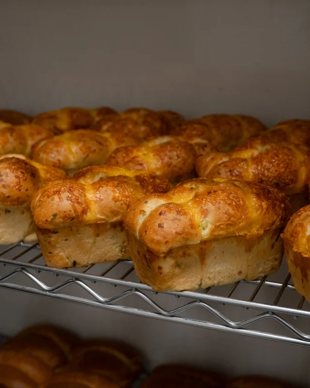Fresh out of the oven and on their way to @birdandthebottle. 
Pimento Cheese Pull-Aparts with cheddar, scallion, and Korean chili butter.
